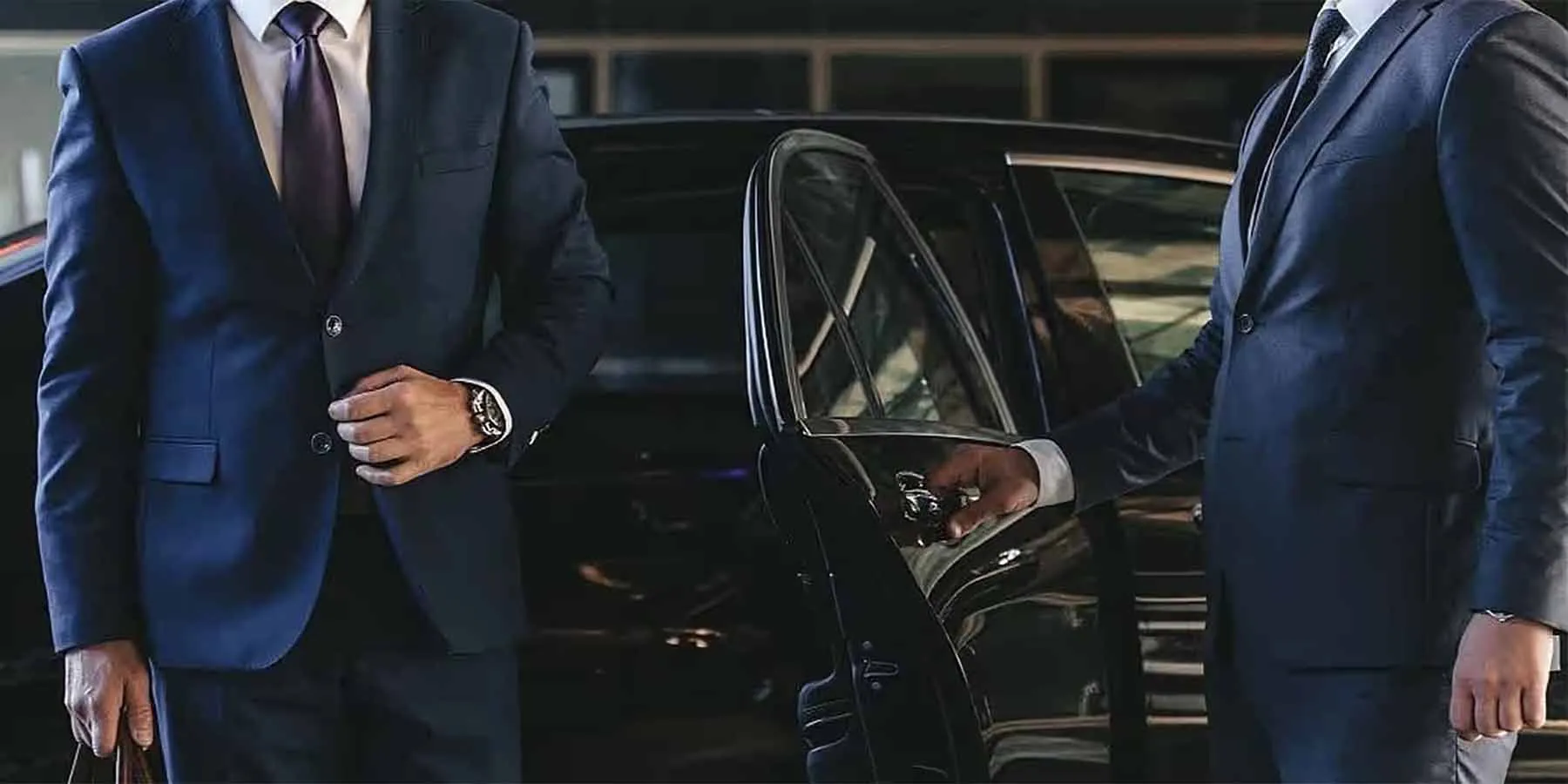 Boston limo service chauffeur opening the door for a business traveler